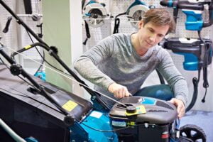 Man fixing a lawn mower